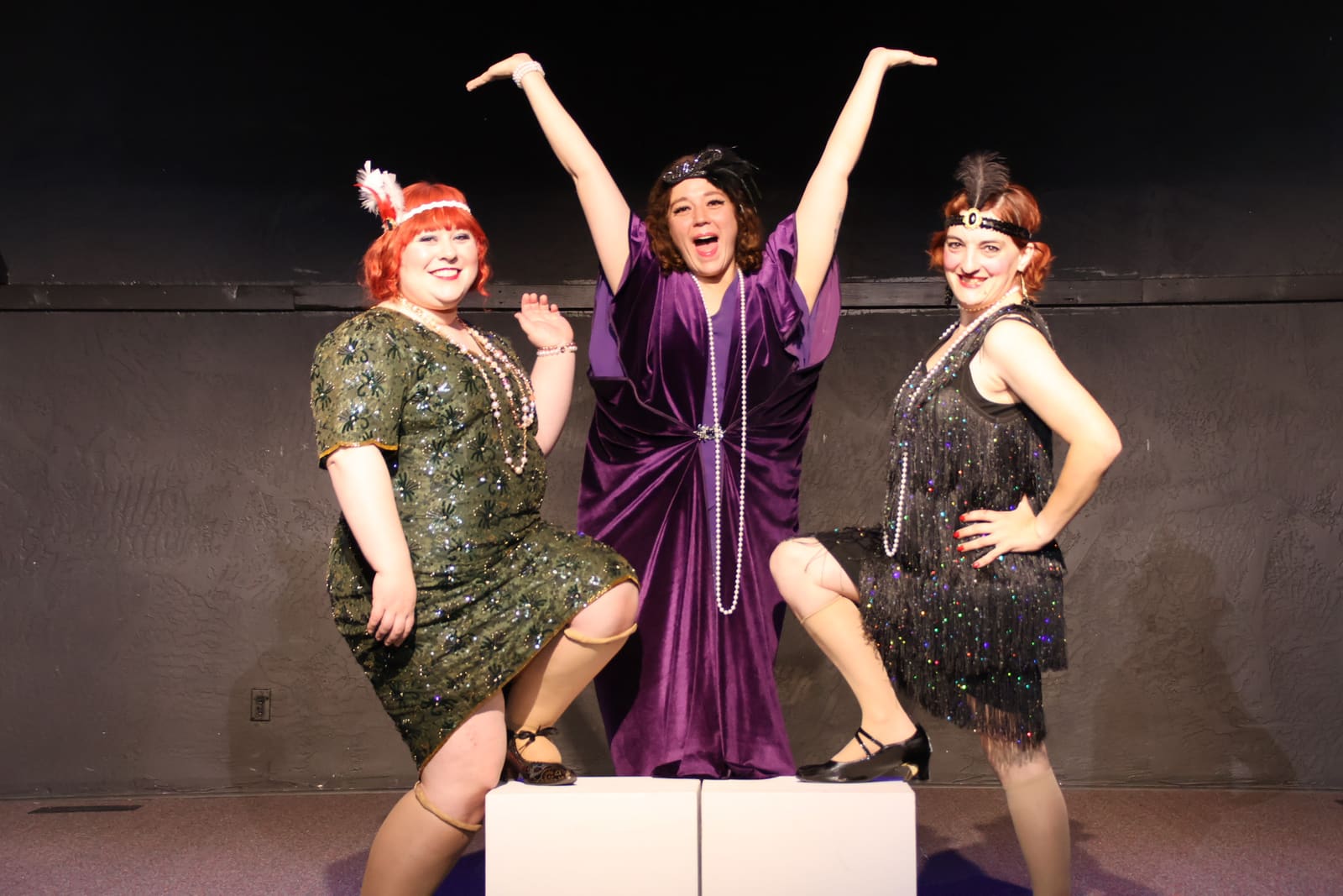 Three performers in 1920s costume on the Lamp Post Creative Learning Center stage
