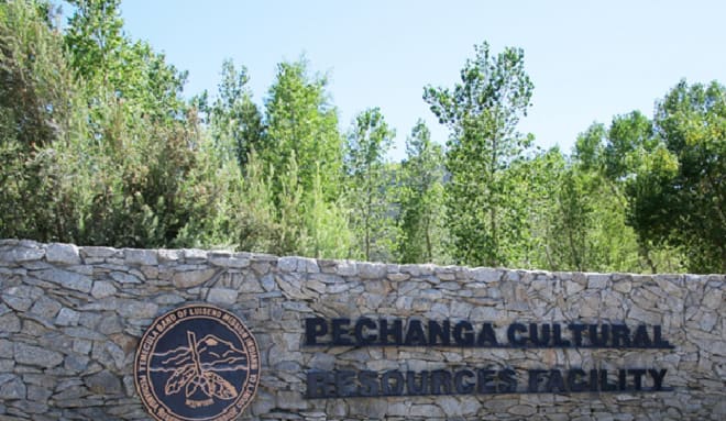 The stone entrance sign of the Pechanga Cultural Resources Facility, trees behind it
