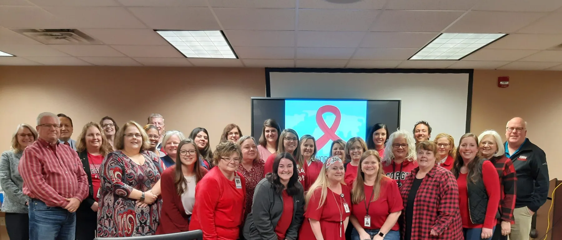 A large District 2 staff gathering in red shirts