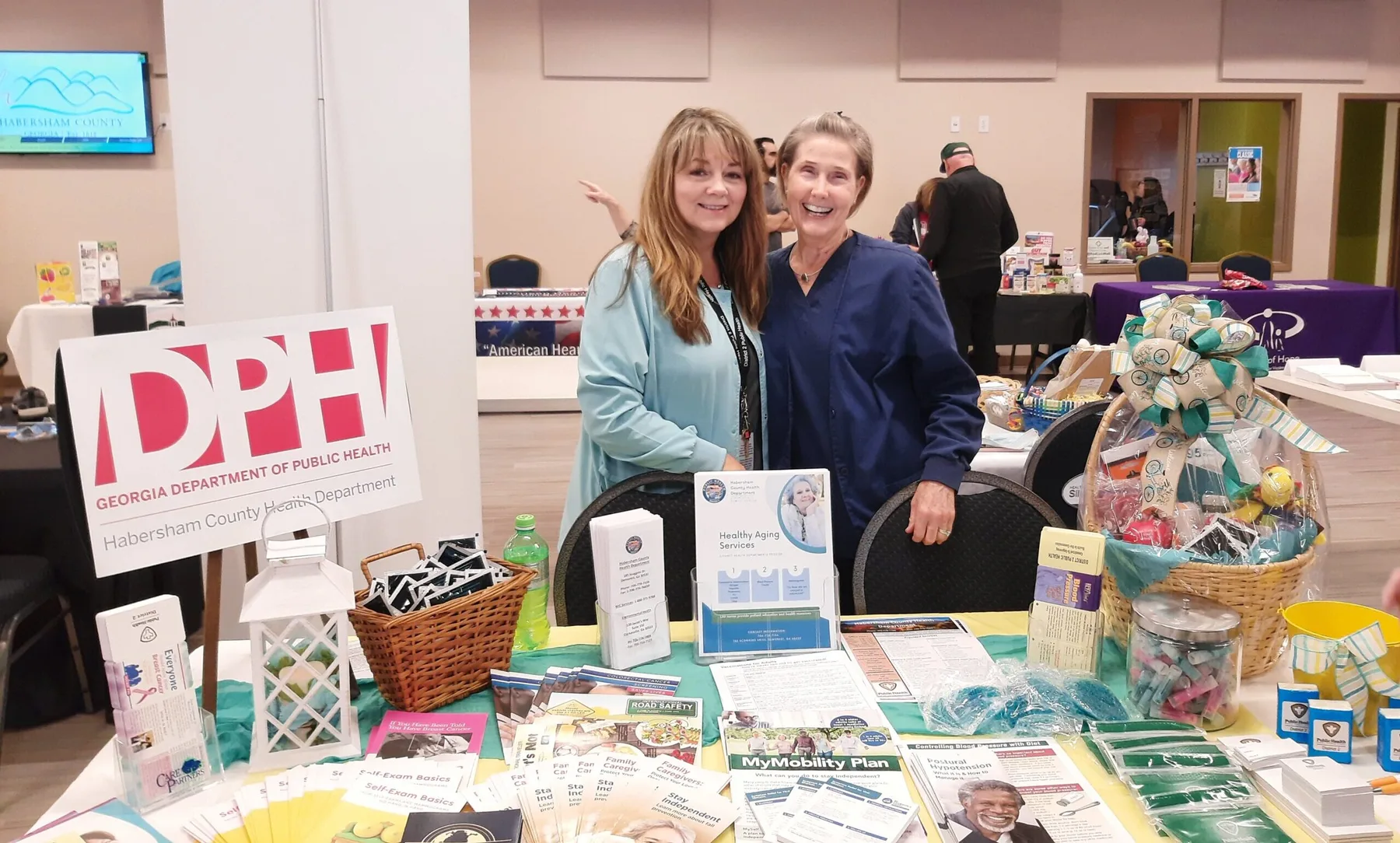 Two District 2 staff members at a public-health information table