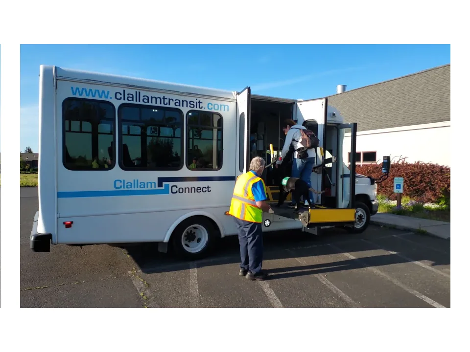 A Clallam Transit driver works the lift as riders board a small Clallam Connect bus.