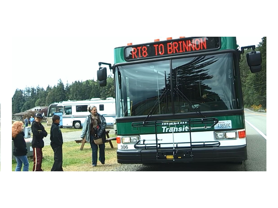 Riders beside a Mason Transit bus on Route 8 to Brinnon.