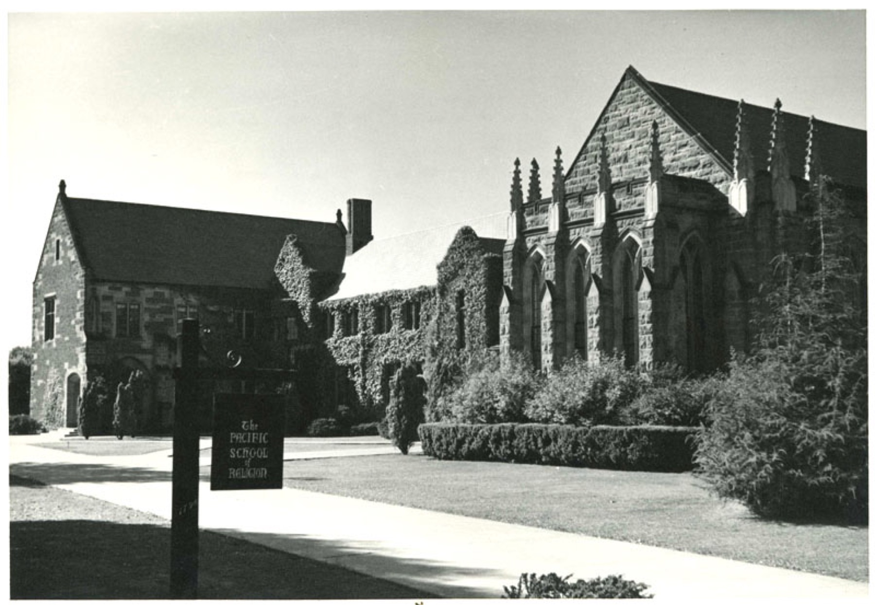 Archival black-and-white view of the ivy-covered chapel and stone academic buildings