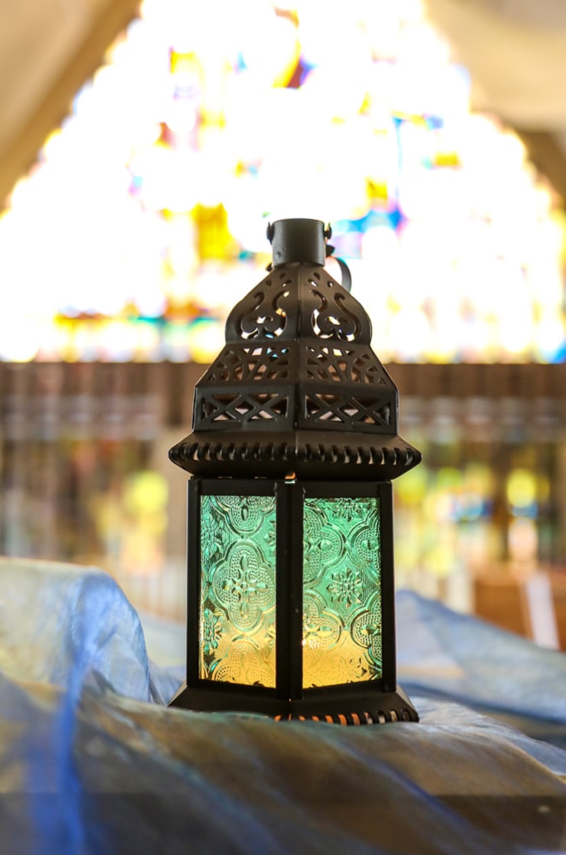 A lantern glows beside stained glass on the PSR campus