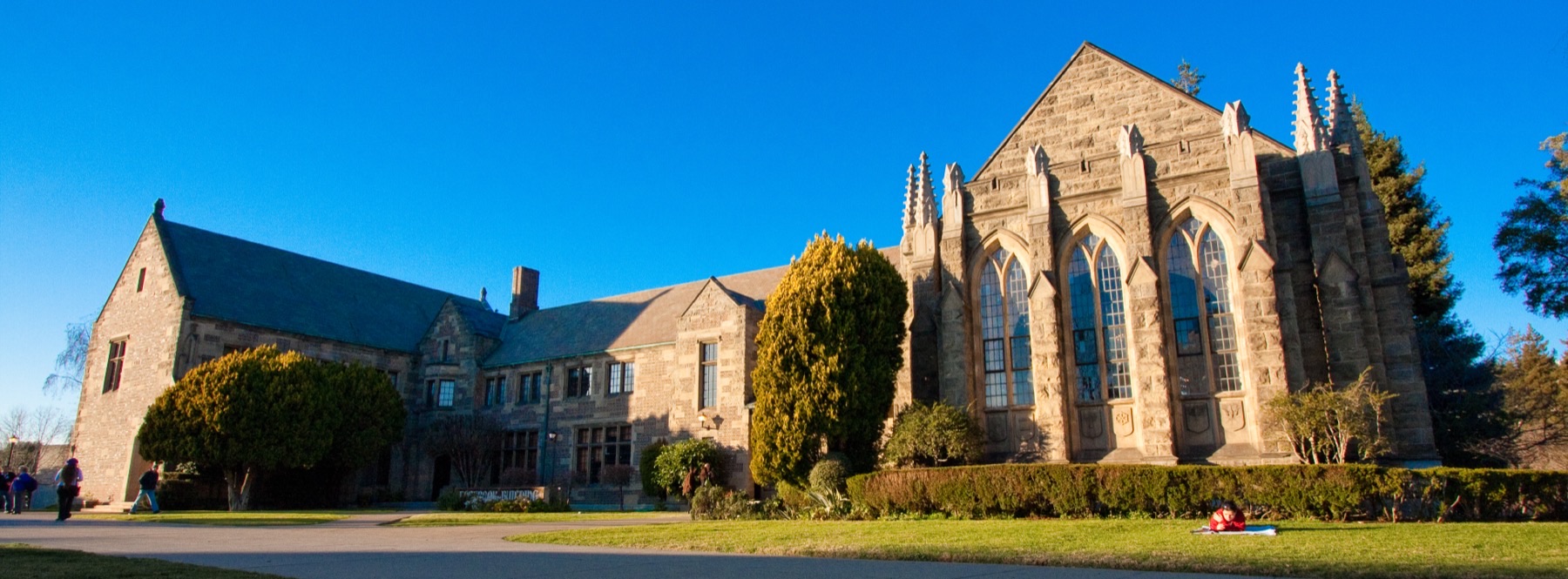 The stone Holbrook Building and Chapel of the Great Commission on Holy Hill beneath a blue sky