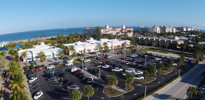 The renovated Ocean Mall plaza near the city beach, with palm trees and storefronts.