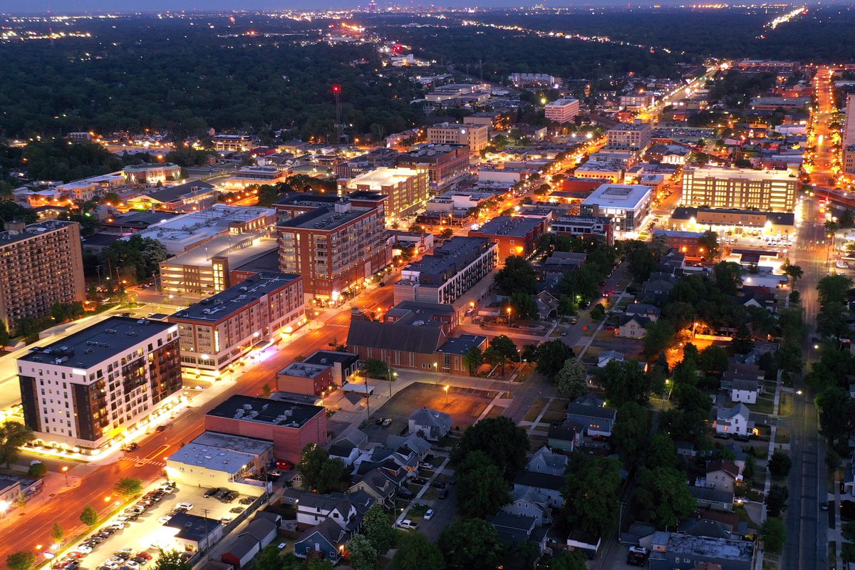 Downtown Royal Oak lit up at dusk from the air, looking south toward Detroit