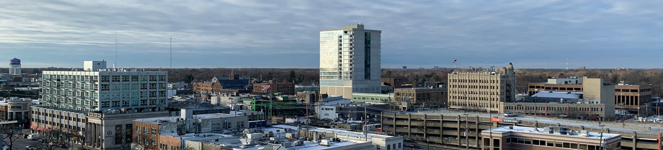 Downtown Royal Oak's skyline from the west: mid-rise offices, lofts, and a parking structure above the storefront blocks
