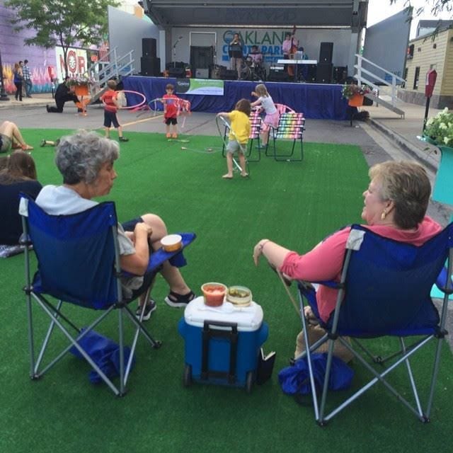Neighbours gathered on the lawn for a Summer Concert Series evening downtown