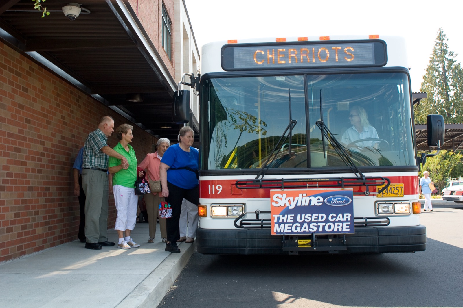 A Cherriots travel trainer helping a rider practice boarding a bus