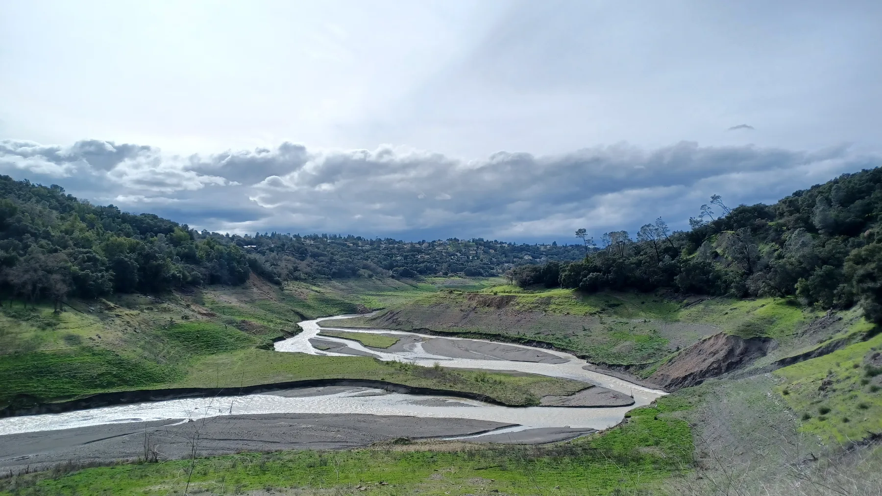 Coyote Creek flowing through the exposed upper Anderson Lake bed in March 2024