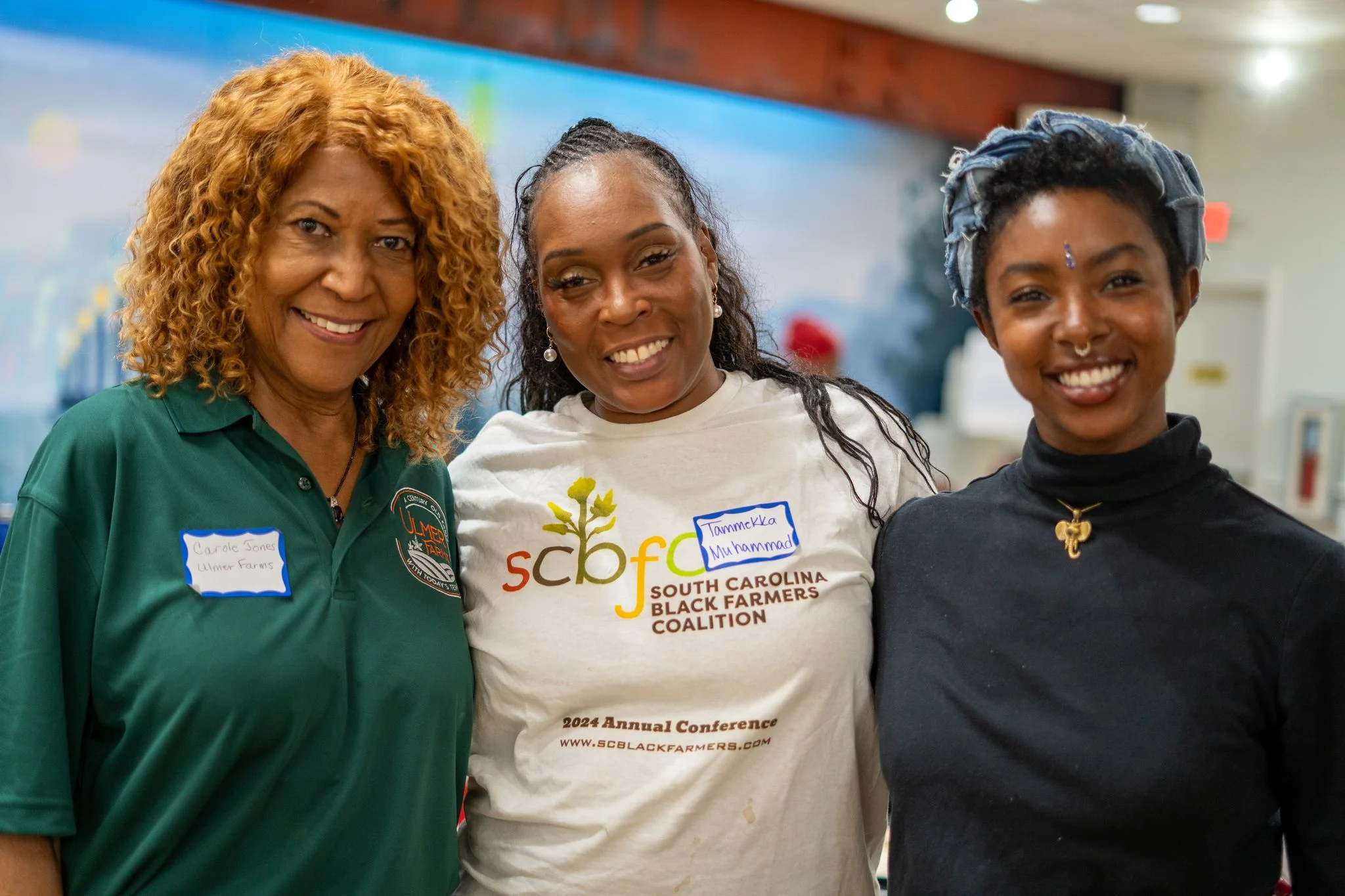 Three people pose together at a Coalition event.