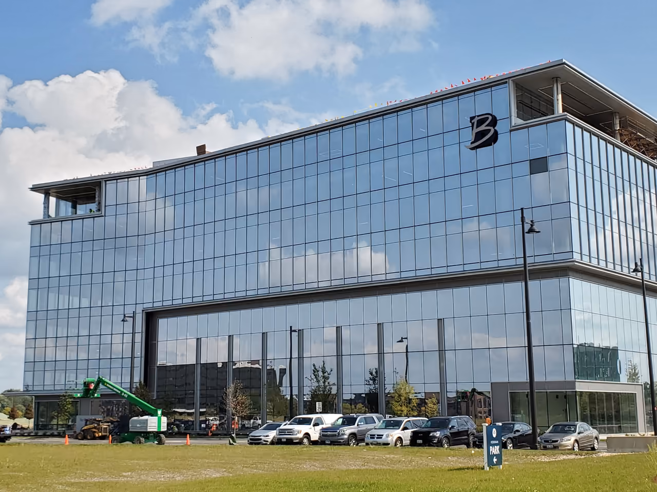 The Boler Company's glass headquarters building beside a landscaped path