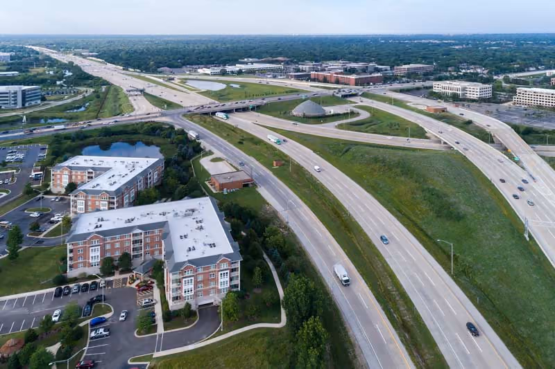 Aerial view of an interstate interchange curving past hotels and office buildings