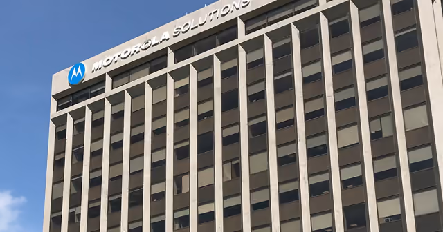 The Motorola Solutions sign on its office tower against a blue sky