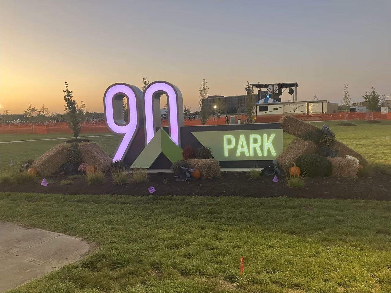 The lit 90 North Park gateway sign at dusk