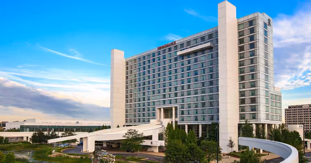 The Renaissance Schaumburg Convention Center Hotel tower above landscaped ponds