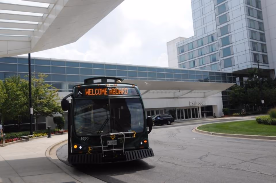 The green Woodfield Trolley at a stop