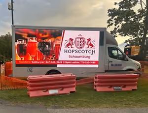 An LED billboard truck at the Septemberfest entrance showing a sponsor's advertisement