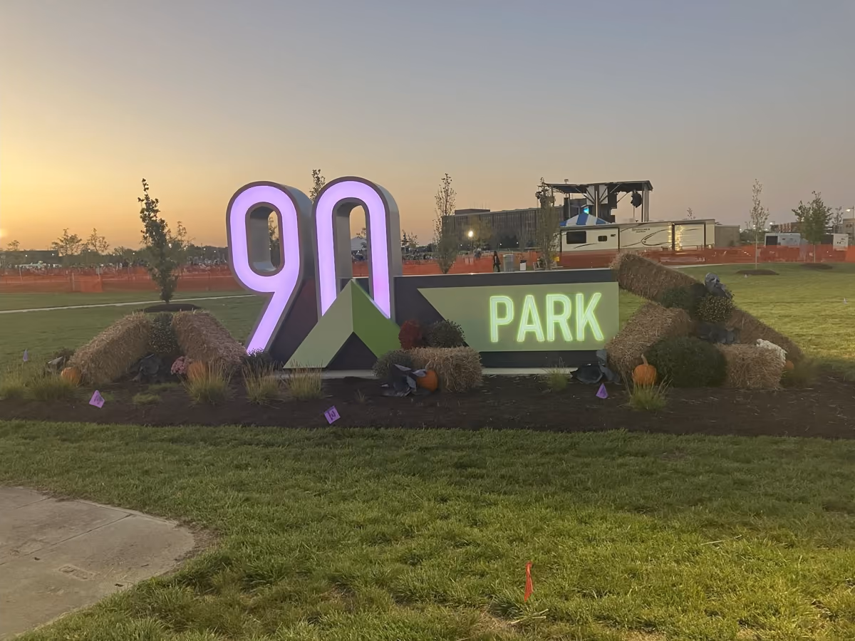 The lit 90 North Park sign at dusk