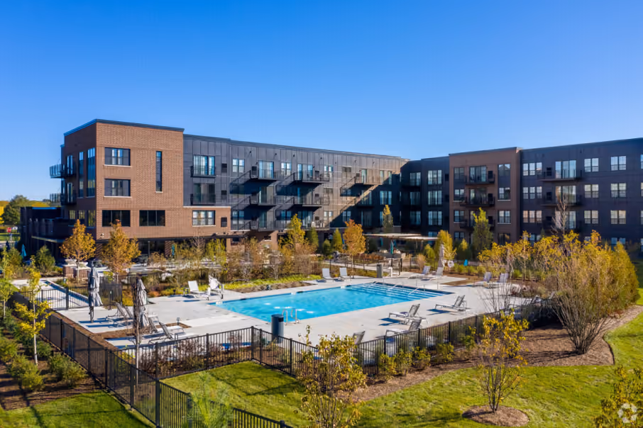 An aerial view of the Element at Veridian Condos at 90 North Schaumburg featuring contemporary architecture, a resort-style pool, and landscaped green spaces.