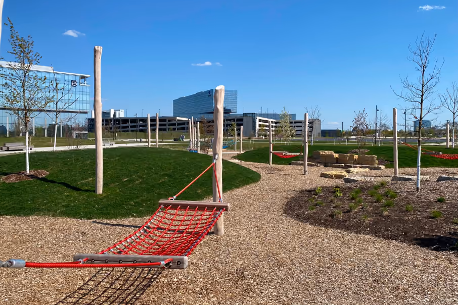 90 North Park in Schaumburg, features open green spaces, hammocks, and walking paths for relaxation and outdoor enjoyment.