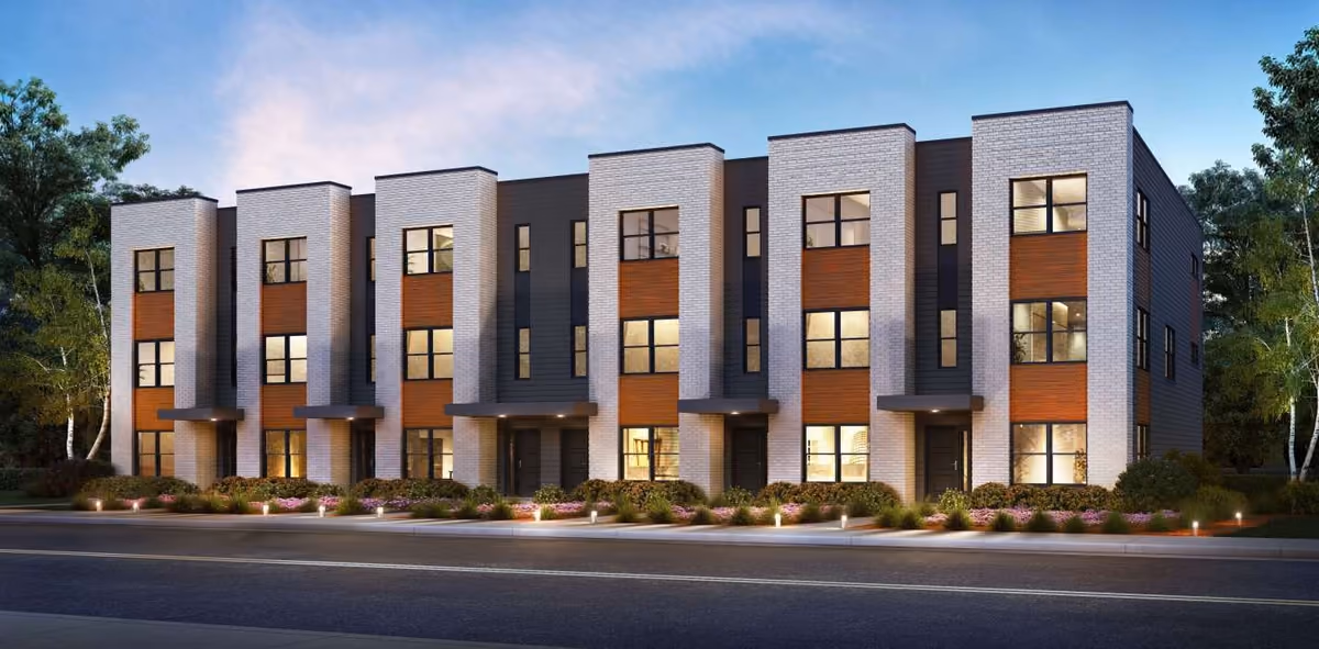 A rendering of three-story rowhomes with brick and white facades
