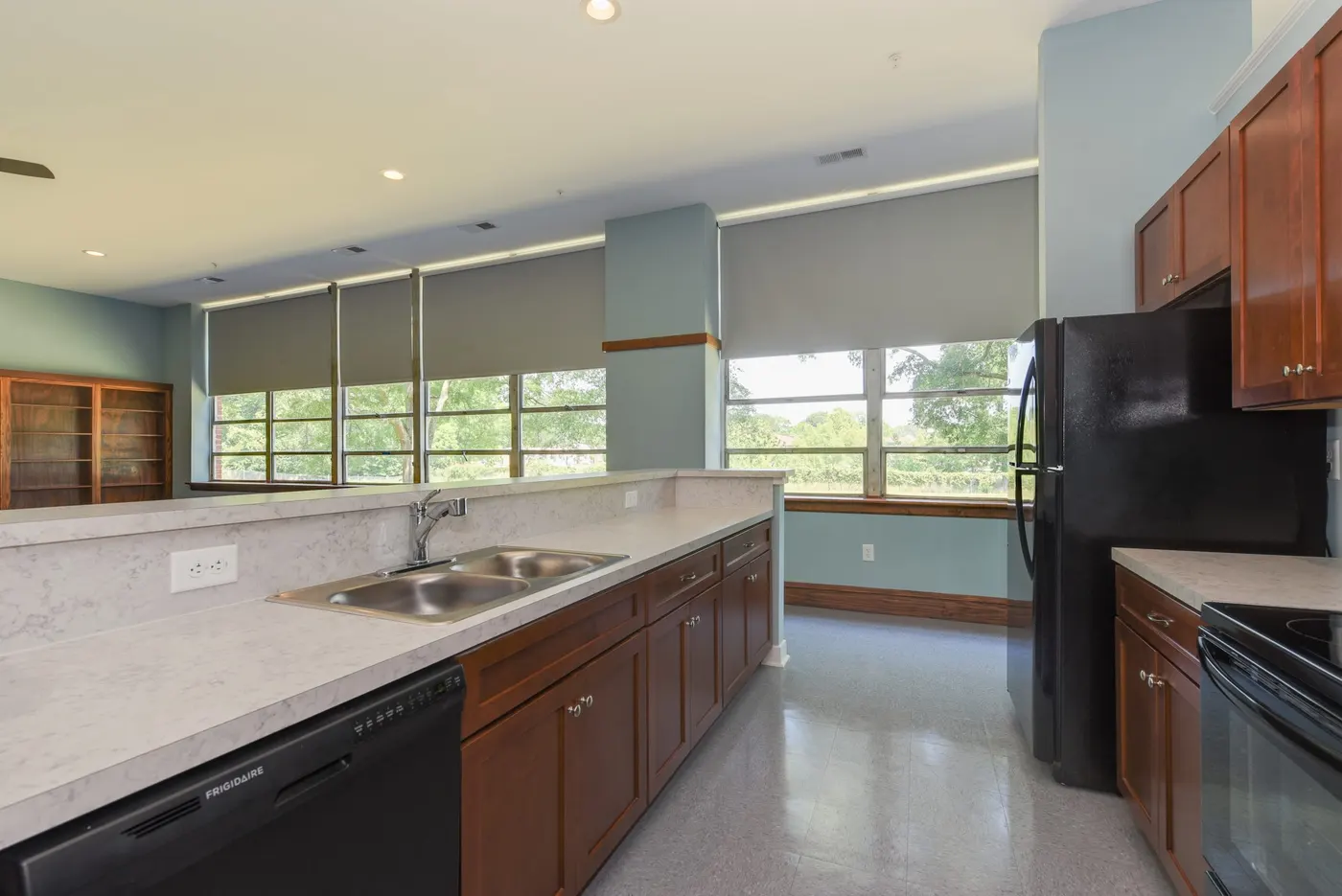 The kitchen of an apartment at the Hayden Village Center, Senior Services' affordable living community in Franklin, opening onto the living area.
