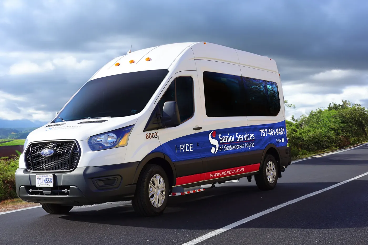A Senior Services I-RIDE vehicle on the road, used to drive seniors to medical appointments and errands.