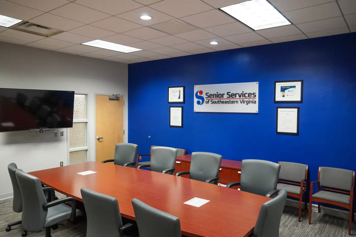 The boardroom at Senior Services' Norfolk office, with the table empty and the chairs pushed in.