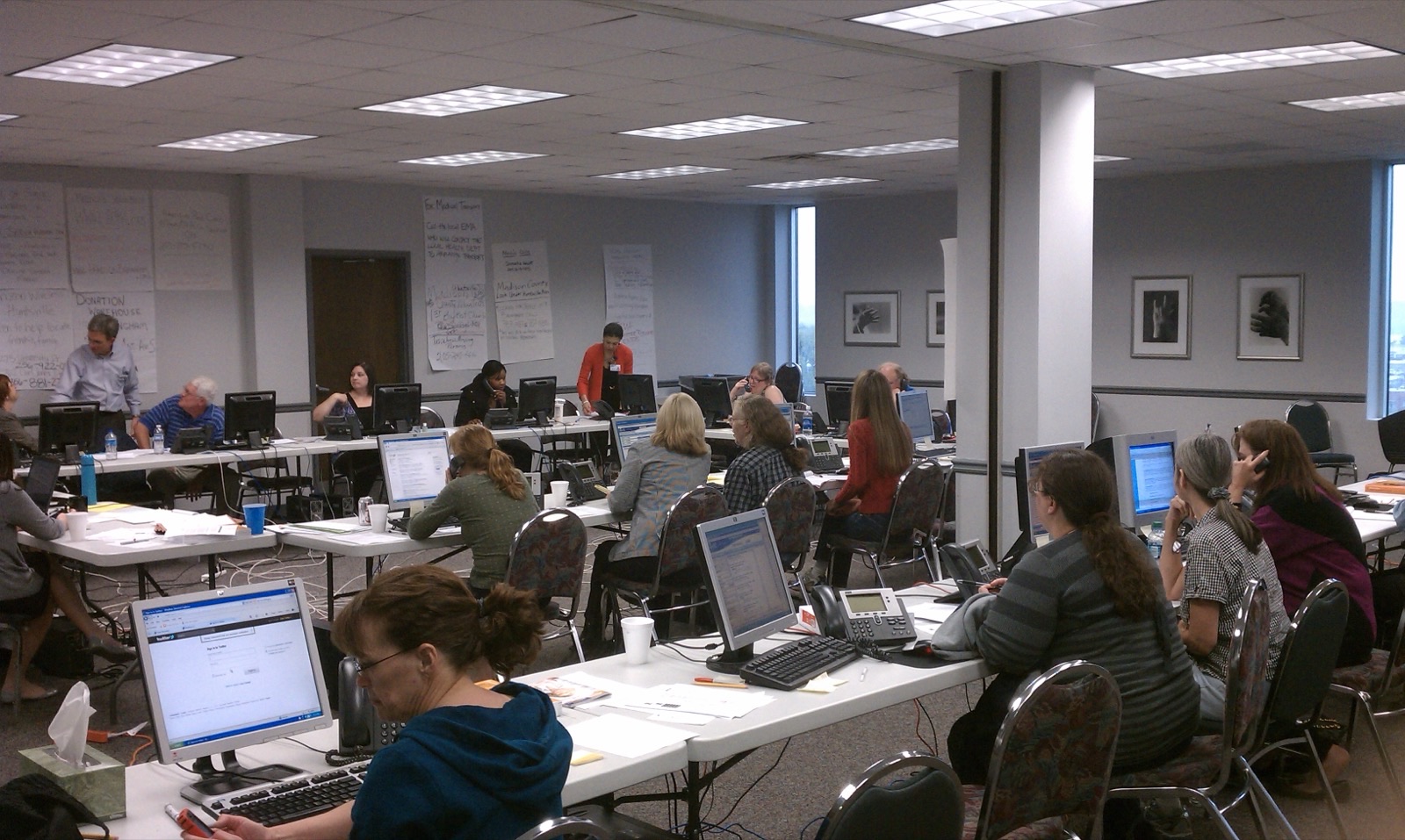 Alabama volunteers staffing a disaster operations center, coordinating response from rows of laptops.