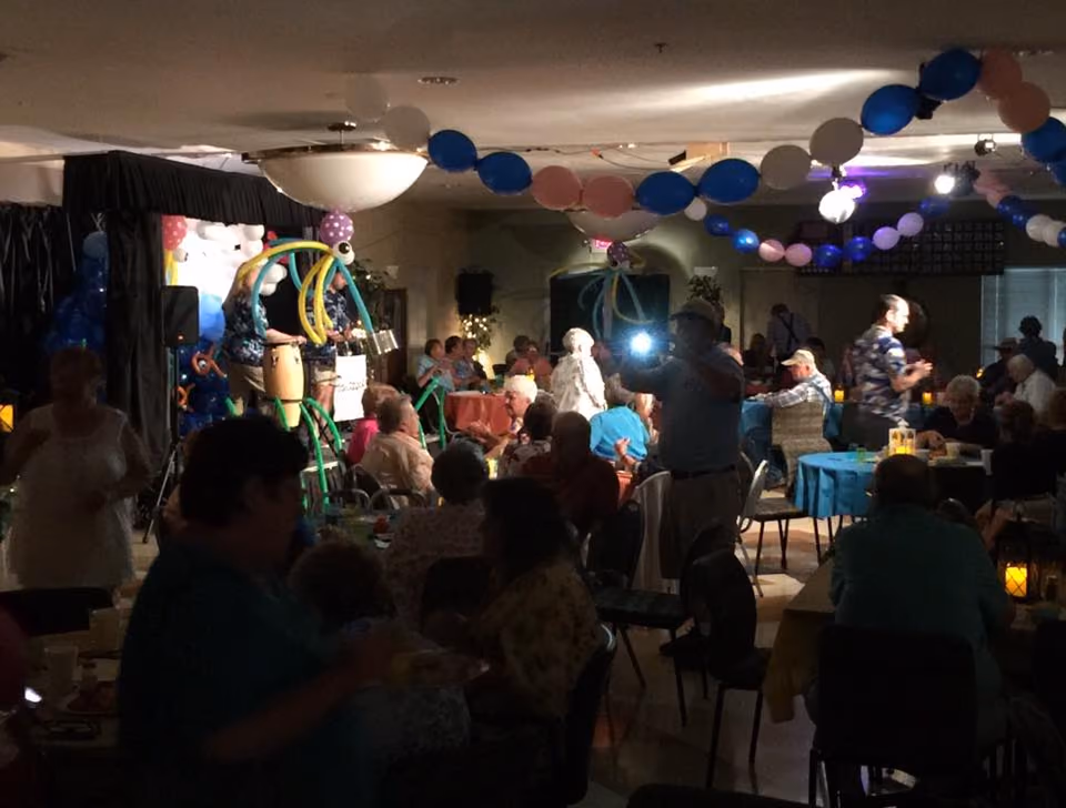 A full dining room decorated with balloons for a party