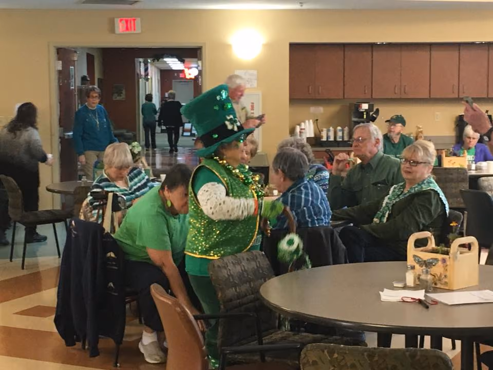 A St. Patrick's Day party in a dining room, a guest in a leprechaun costume among the tables