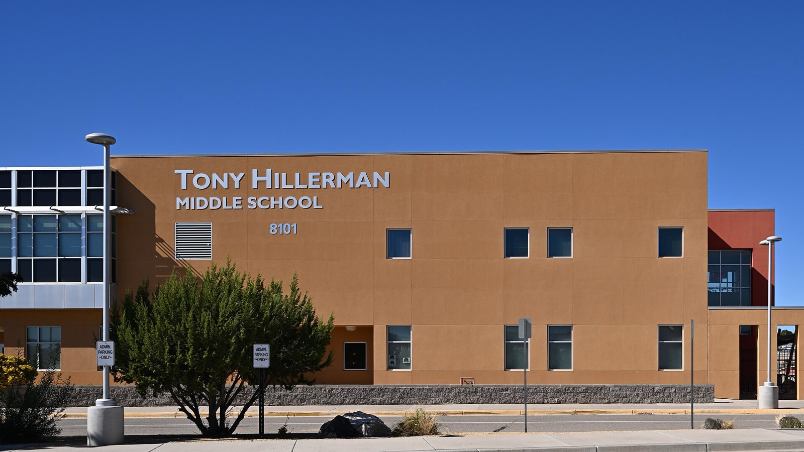 The front entrance of Tony Hillerman Middle School in Albuquerque under a clear New Mexico sky
