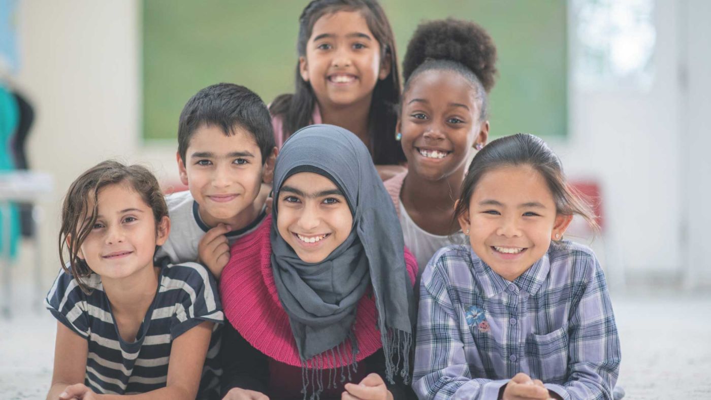 A diverse classroom where students and a teacher engage together in literacy instruction