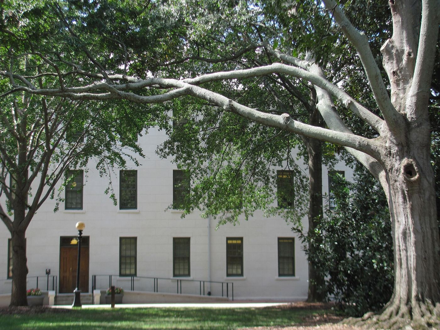 New College on the North Campus quad, a red brick building with white-railed balconies above a row of trees
