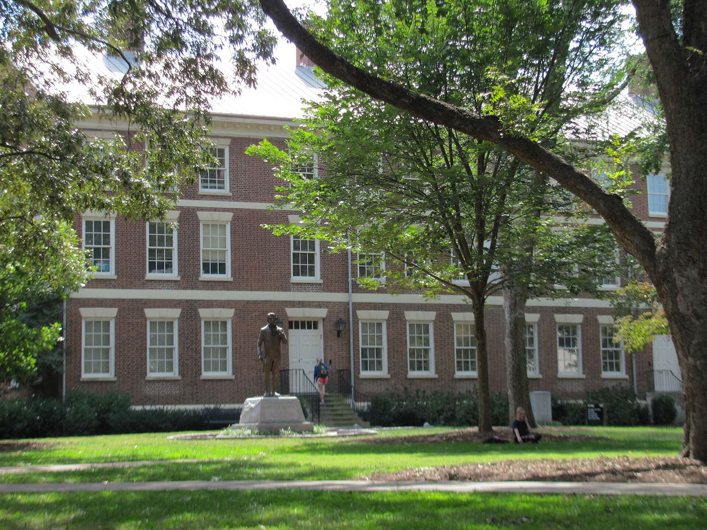 Old College, a three-story red brick building with white trim, seen across the North Campus lawn
