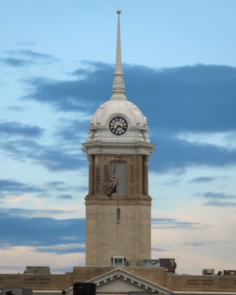 The Courthouse clock tower and spire against an evening sky.