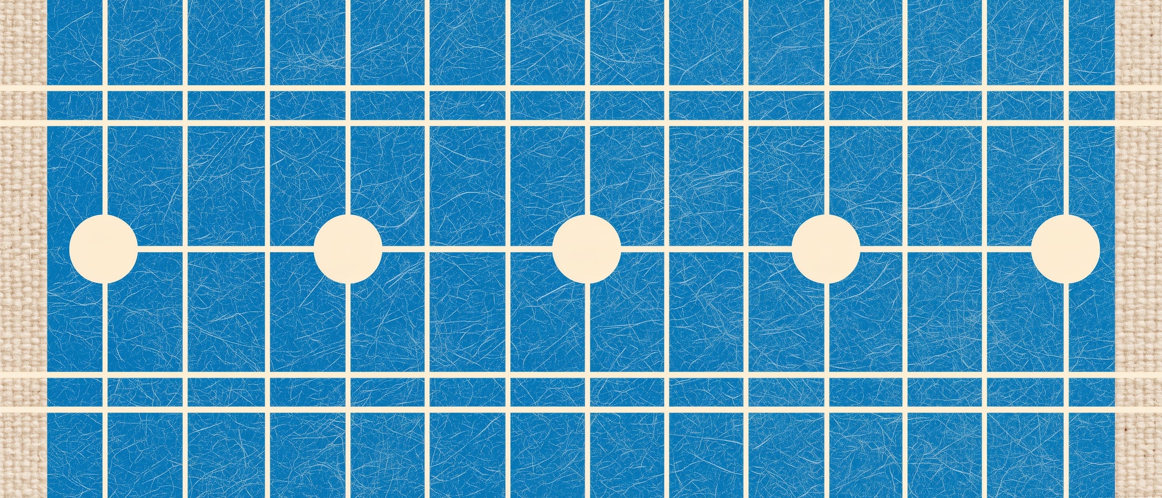 A woven blue grid with five cream circles