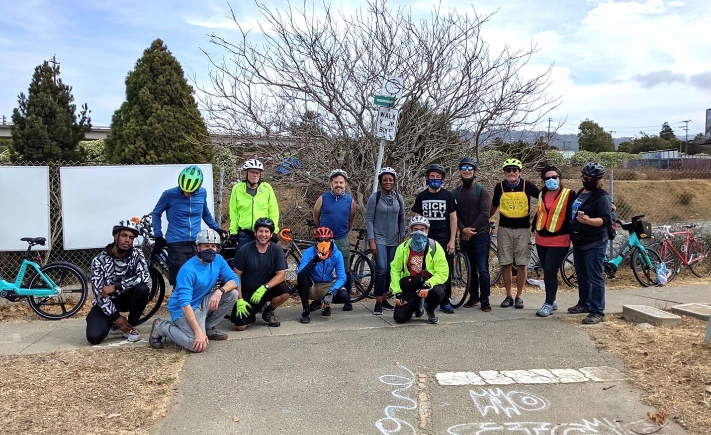 Rich City Rides cyclists posing with their bikes beside a West County trail